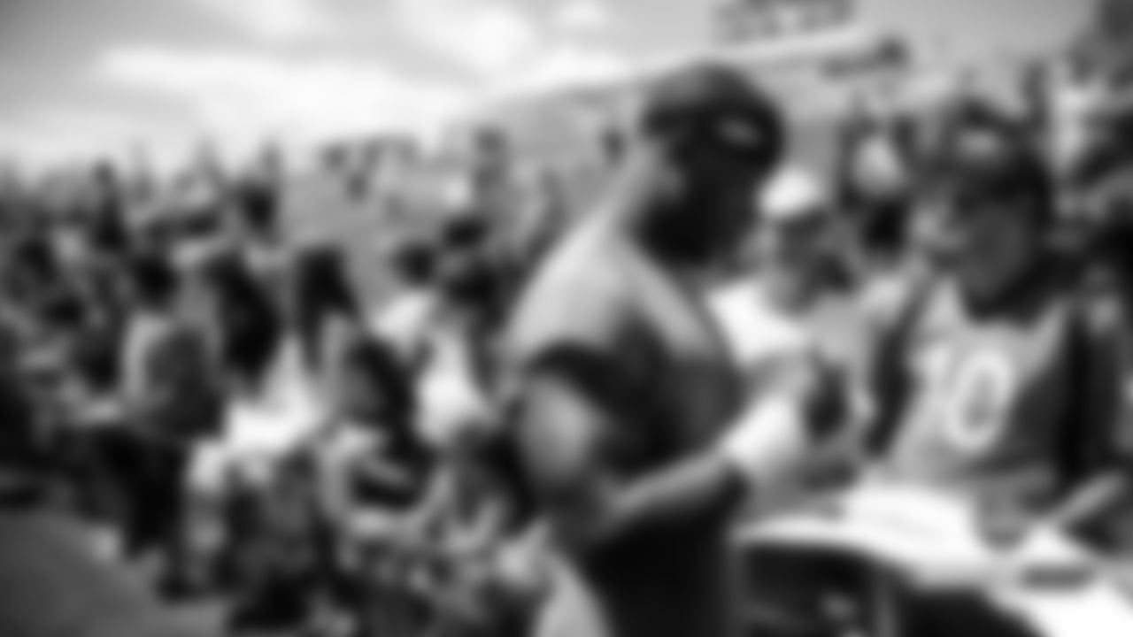 Theo Riddick signs autographs after practice on Day 12 of training camp on August 4, 2019.