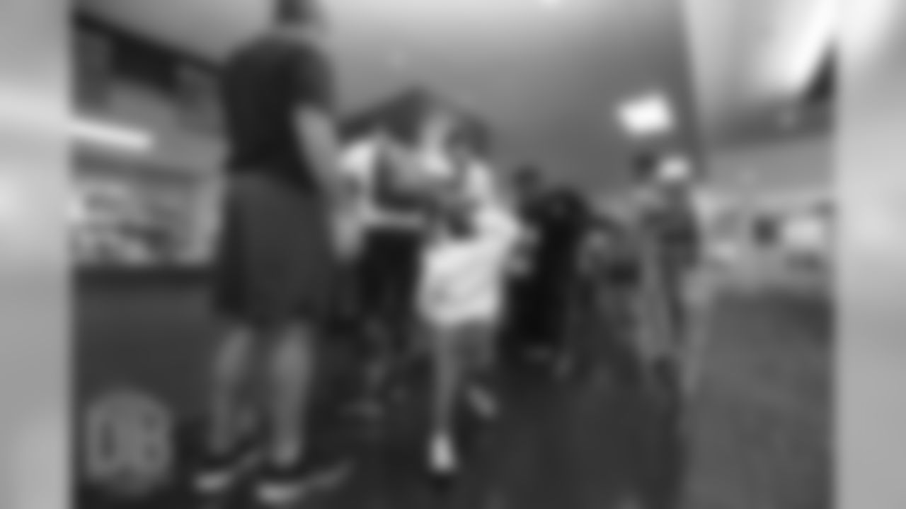 Emmanuel Sanders's son Princeton high-fives Demaryius Thomas in the cafeteria during a family breakfast at UCHealth Training Center on September 15, 2018.