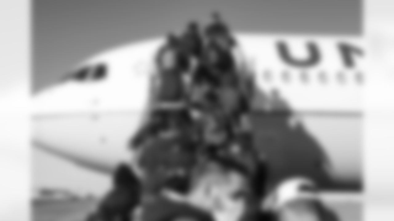 Players on the tarmac at Denver International Airport on December 4, 2021 during the team's travel to Kansas City in Week 13. (Photo by Joe Abdellah)
