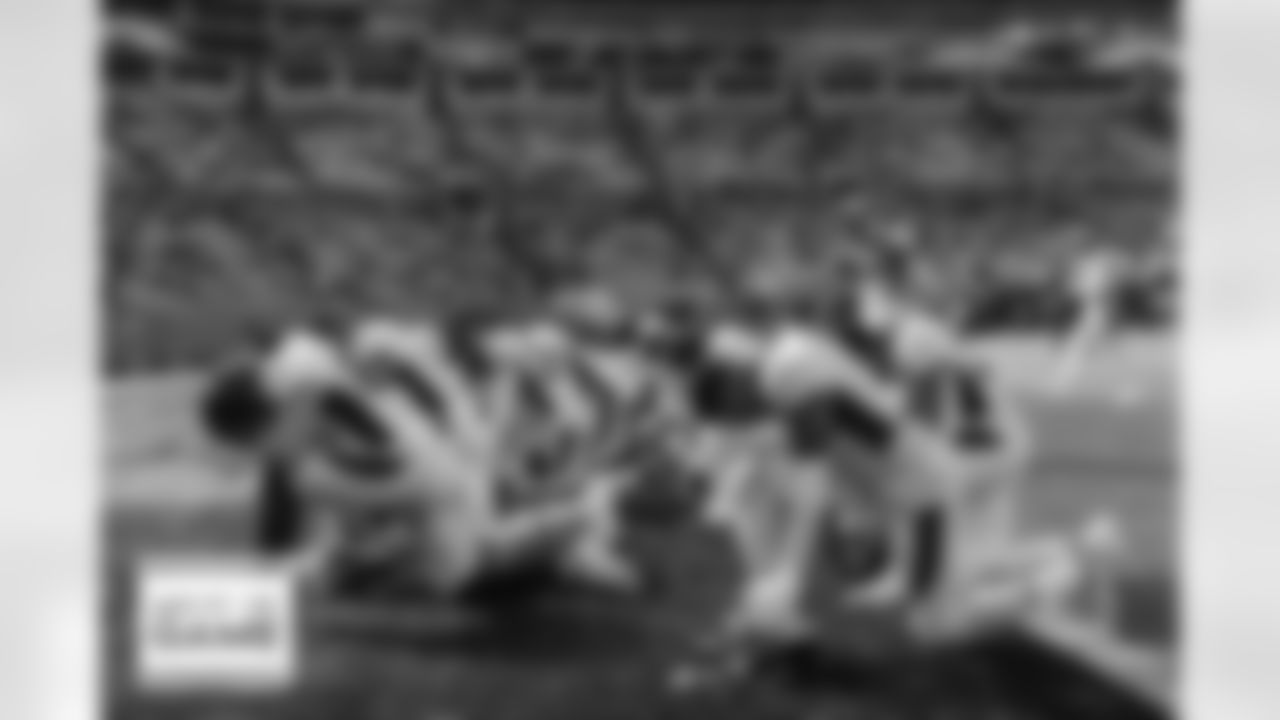 Pat Surtain II, Andrew Beck and others kneel in the end zone in prayer before the Broncos' Week 12 game against the Carolina Panthers at Bank of America Stadium in Charlotte, North Carolina on November 27, 2022. (Photo by Ben Swanson)