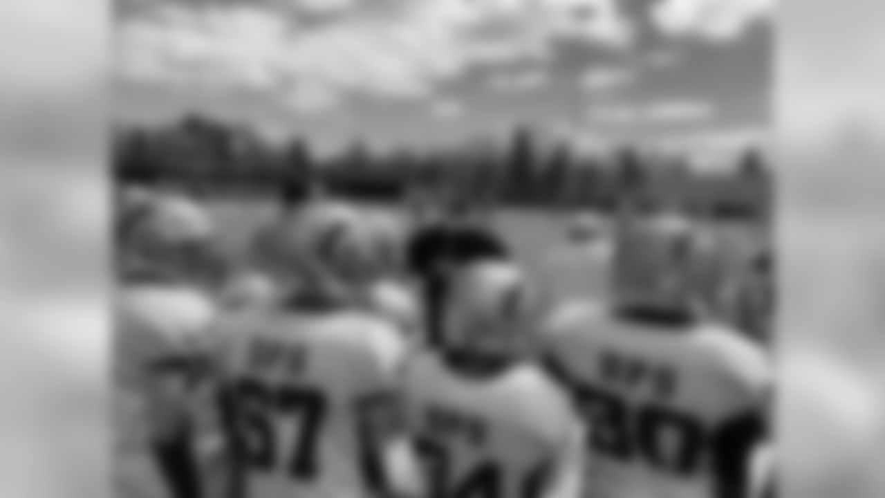 Students on a Futures Football team watches their teammates from the sideline during a game.