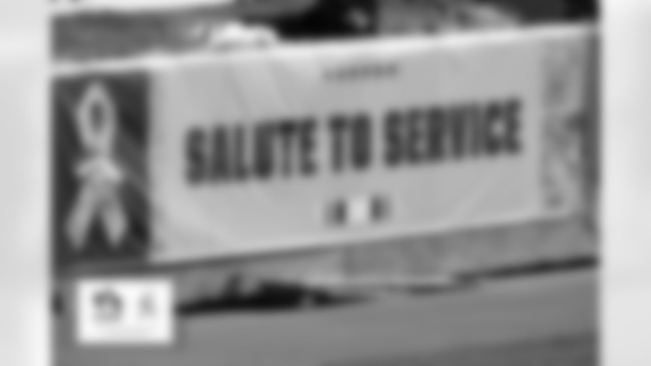 A view of Salute to Service signage on the field for the Broncos Week 11 game against the Miami Dolphins on November 22, 2020 at Empower Field at Mile High. Photo by Eric Lars Bakke