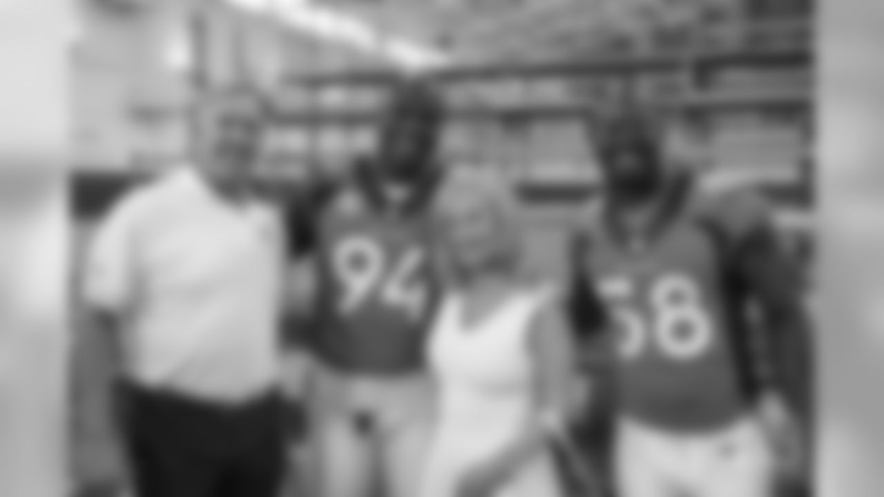 Executive Vice President of Football Operations/General Manager John Elway, outside linebacker DeMarcus Ware (94), Annabel Bowlen, outside linebacker Von Miller (58) at the Broncos' 2016 team photo picture day at the Pat Bowlen Fieldhouse.