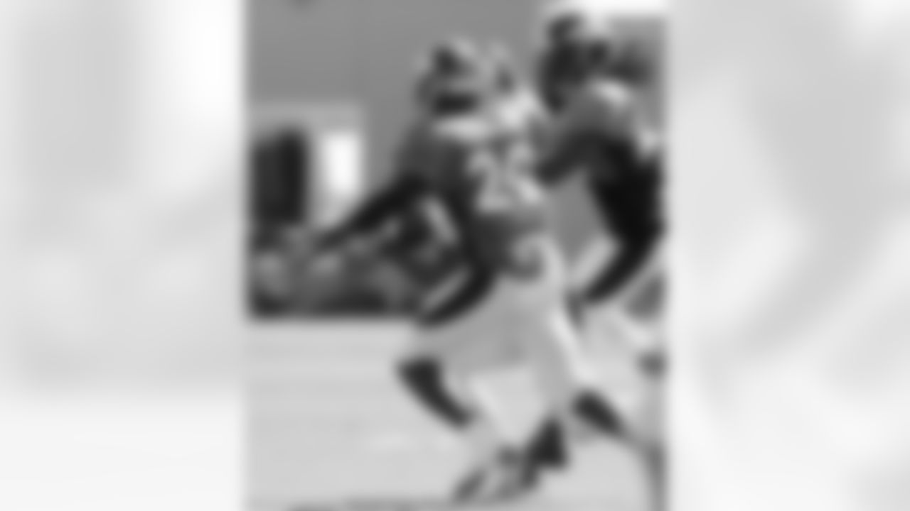 Caldwell makes a catch between two defenders.