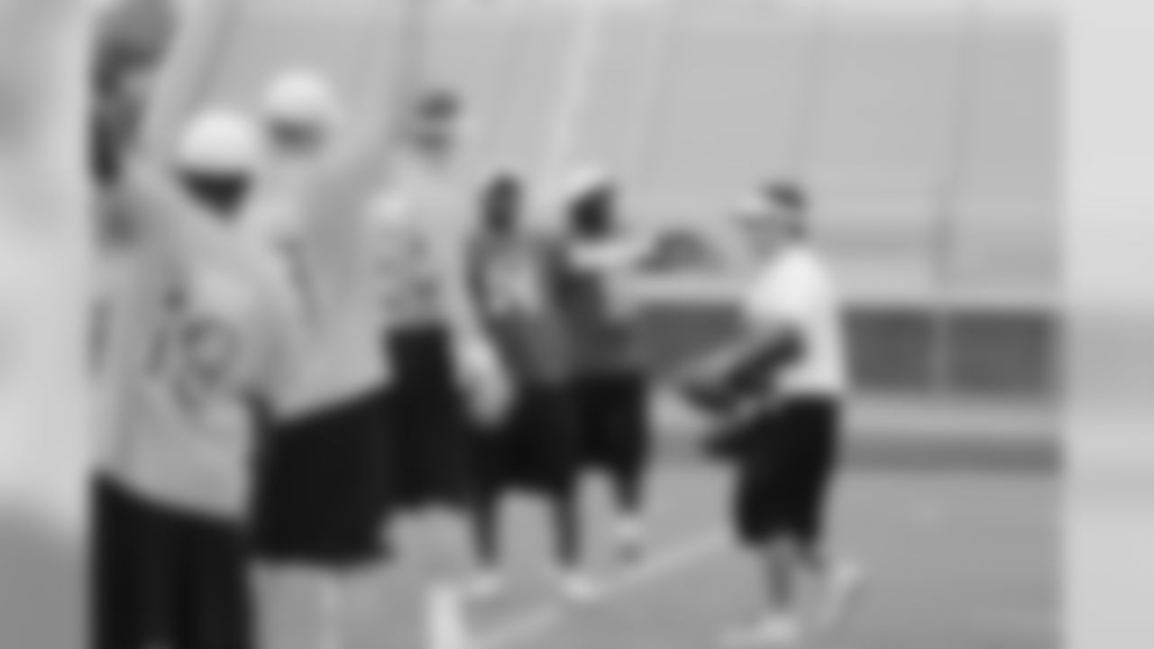 Champ Bailey stretches in front of Peyton Manning.