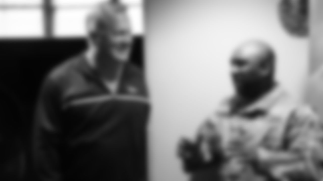 Karl Mecklenburg converses with a military member during the Denver Broncos' Salute To Service Caravan at Fort Carson, Colorado on October 30, 2018.