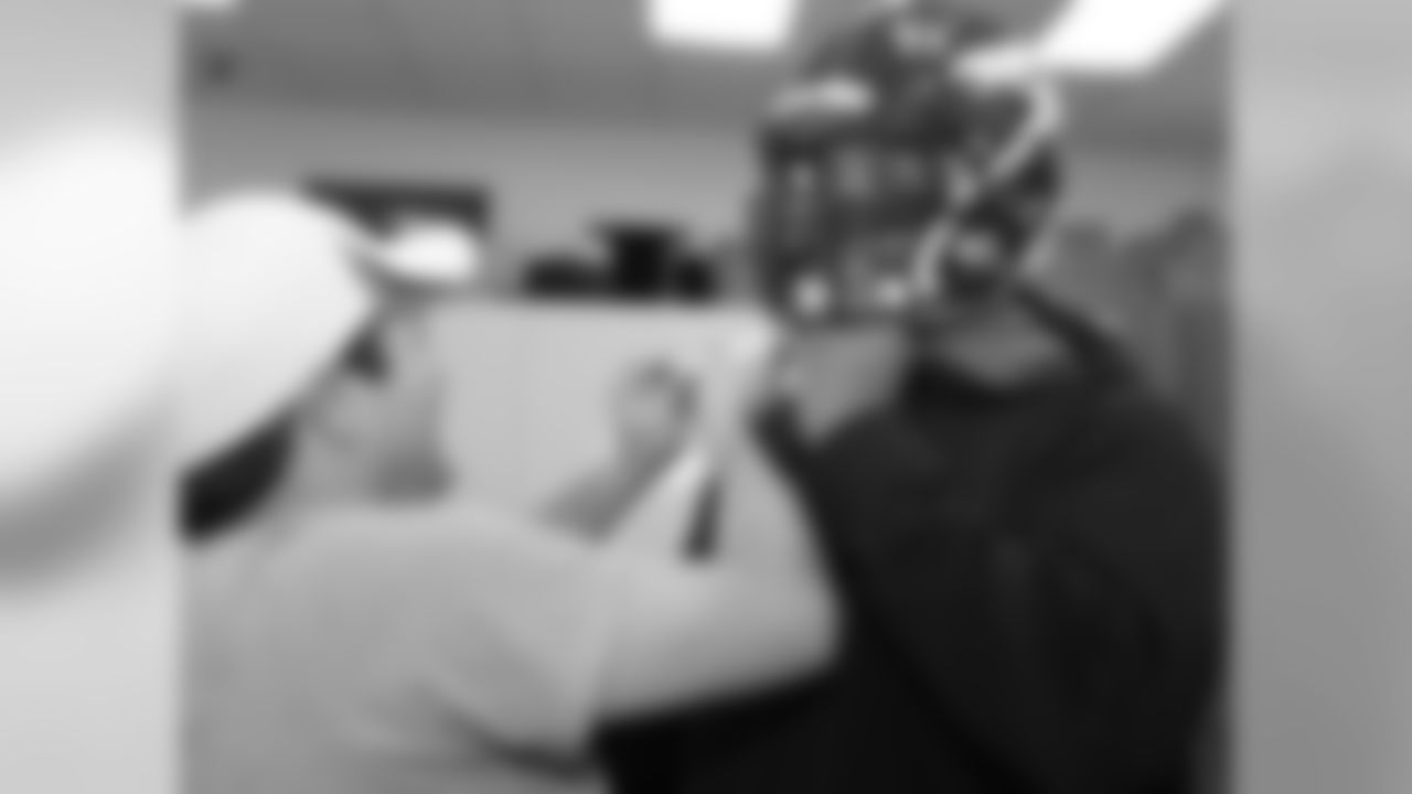 The Broncos' first-round pick gets his chinstrap adjusted.