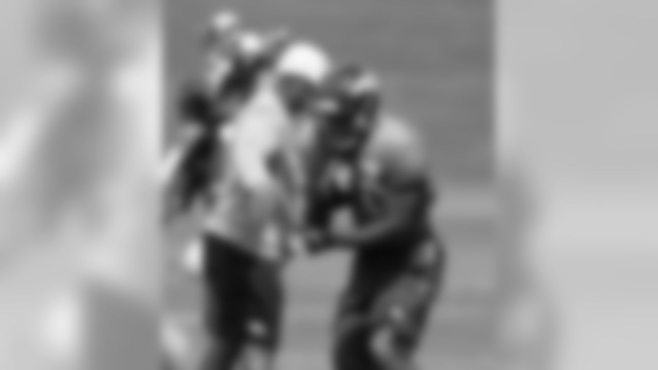 Thompson protects the football as RB Coach Eric Studesville tries to strip it.