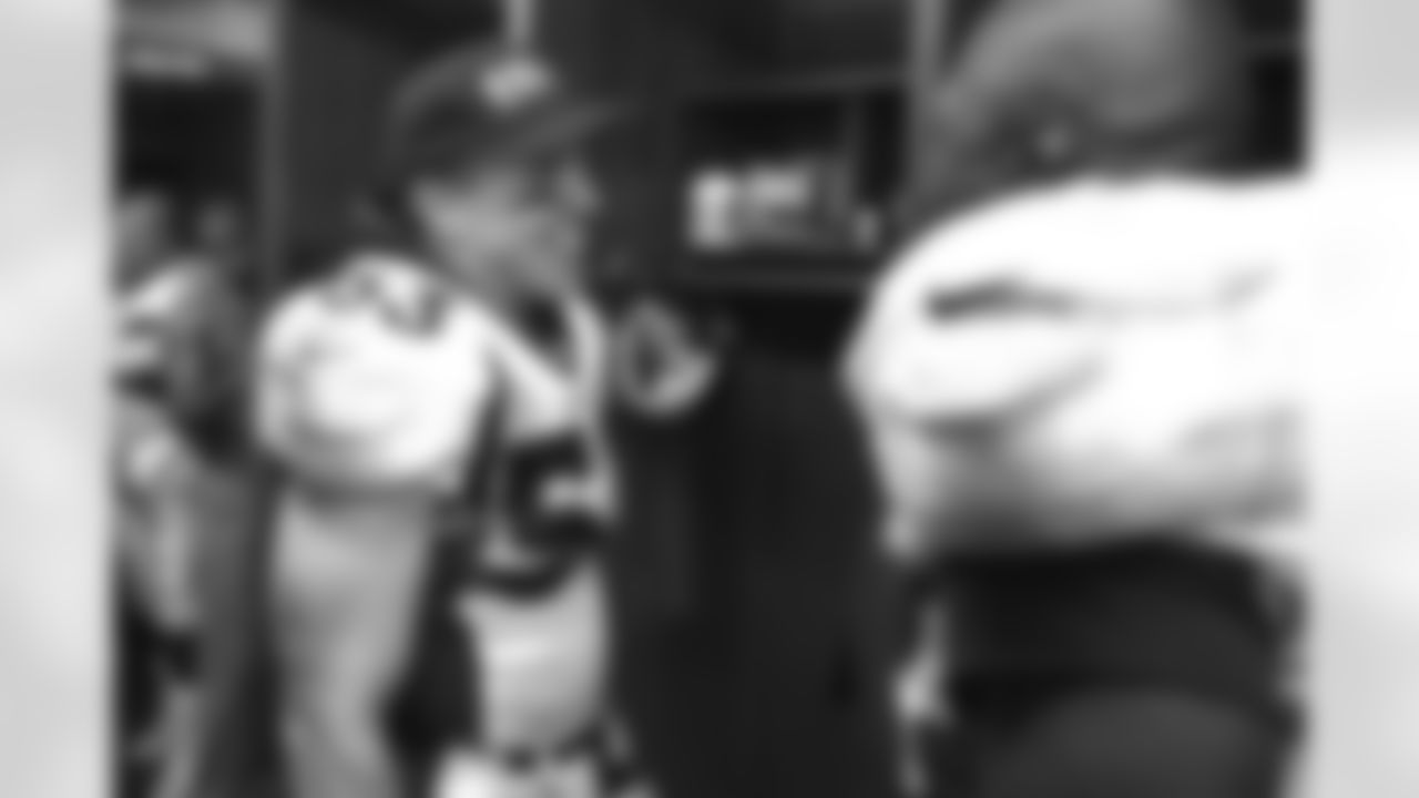 Kansas City: Bill Romanowski (ball cap) and Keith Burns celebrate in the locker room after the Broncos win their second round playoff game against the Kansas City Chiefs at Arrowhead Stadium in Kansas City, MO on January 4, 1998.