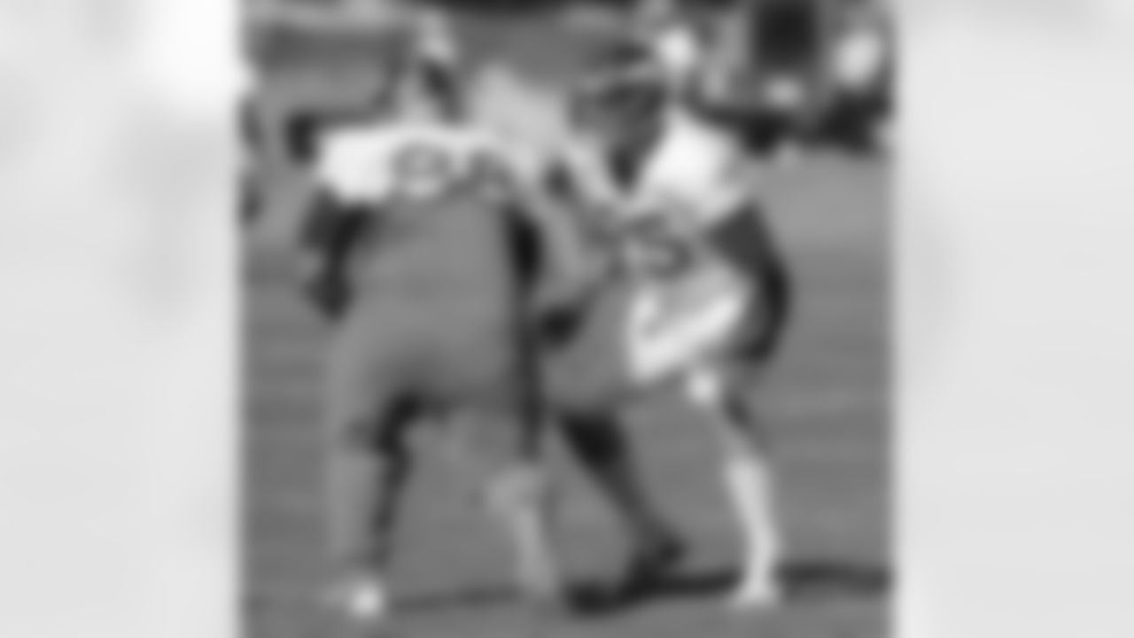 DE Derek Wolfe gets ready to wrap up DT Sealver Siliga during a drill.