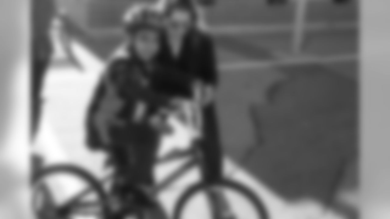A bike recipient tests out his new bike during a bike distribution at Green Valley Elementary School in Denver on December 18, 2018.
