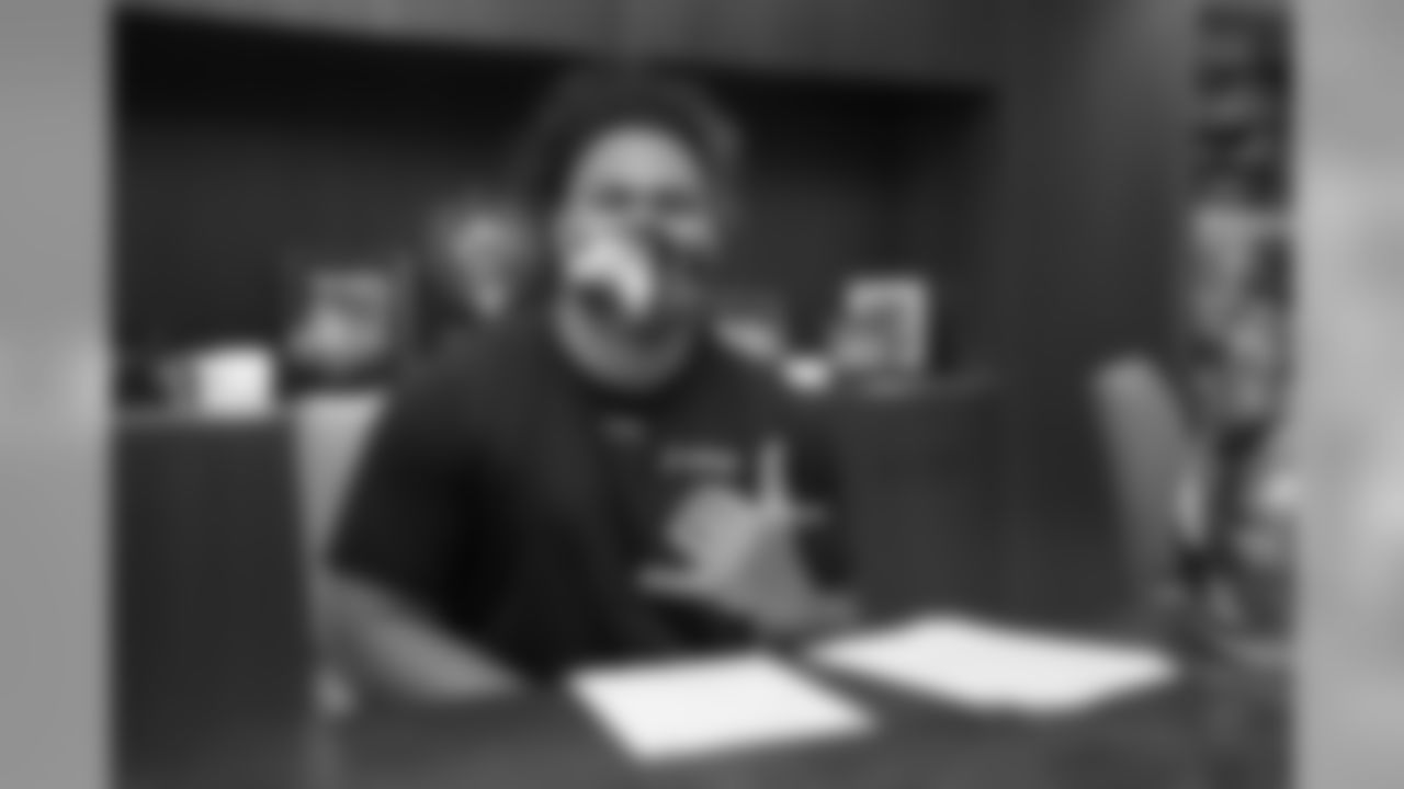 Netane Muti signs his rookie contract in Pat Bowlen's conference room at UCHealth Training Center on July 27, 2020. (Photo by Ben Swanson)