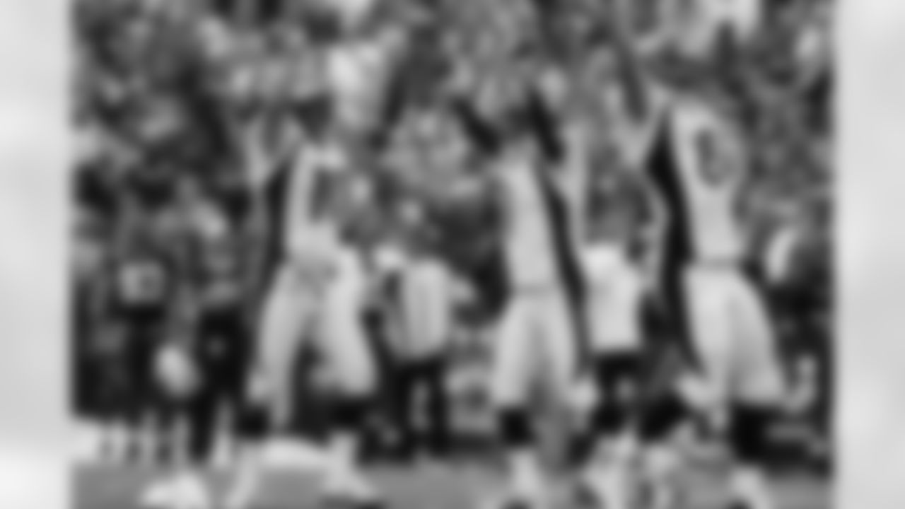 Denver Broncos holder Todd Sauerbrun and kicker Jason Elam along with Nate Jackson erupt with joy as Elam's game-winning field goal attempt crosses the crossbar with no time remaining against the Buffalo Bills.