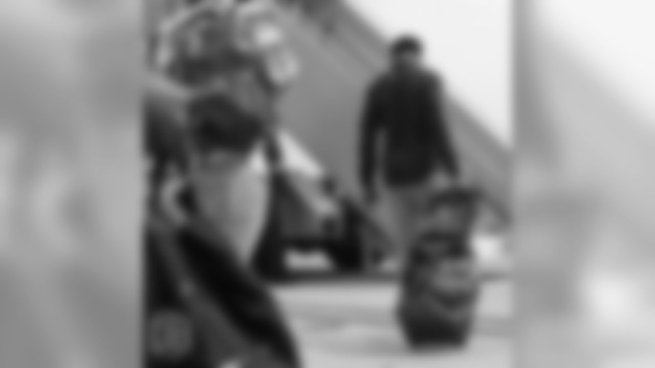 Demaryius Thomas pulls his bags, including one with Tupac's face on it, as he walks on the tarmac at Denver International Airport during the team's travel for their preseason game against the Washington Redskins on August 23, 2018.