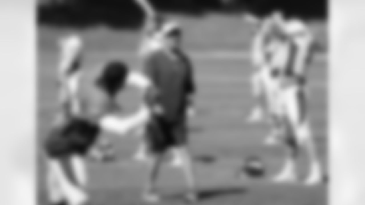 Head Coach John Fox smiles during the stretching period.