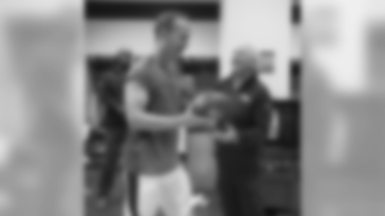 Denver Broncos Head Coach John Fox presents Peyton Manning with game ball after Denver's 31-24 win over the Indianapolis Colts in the NFL game at Sports Authority Field in Denver,Colo. September 7, 2014