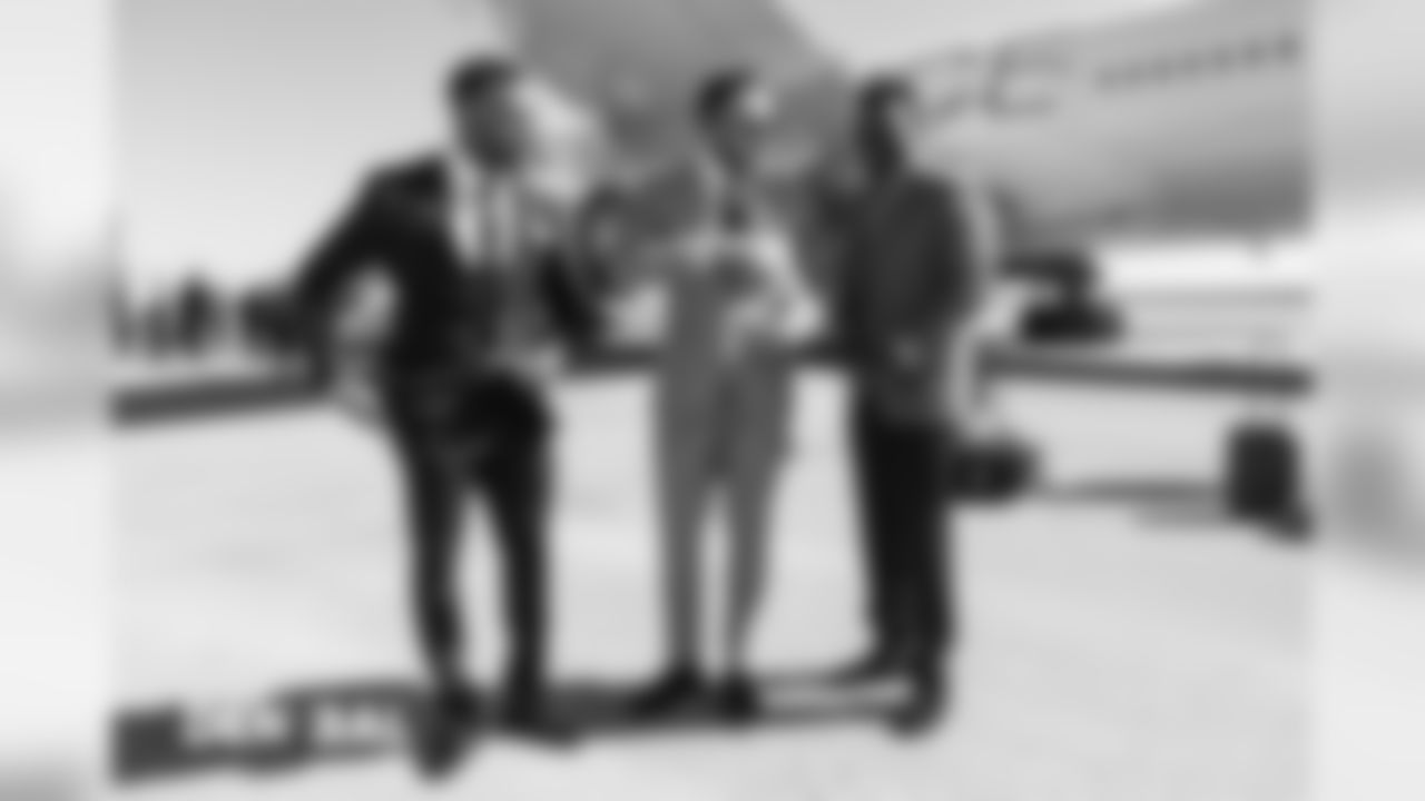 Brandon Marshall, Shane Ray and Shaquil Barrett walks to the plane on the tarmac at Denver International Airport during the team's travel for their Week 3 game against the Baltimore Ravens on September 22, 2018.