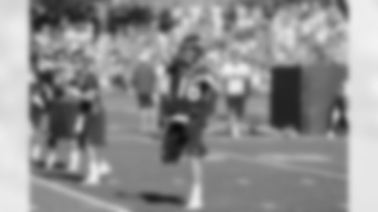 QB Peyton Manning fires a pass before practice.