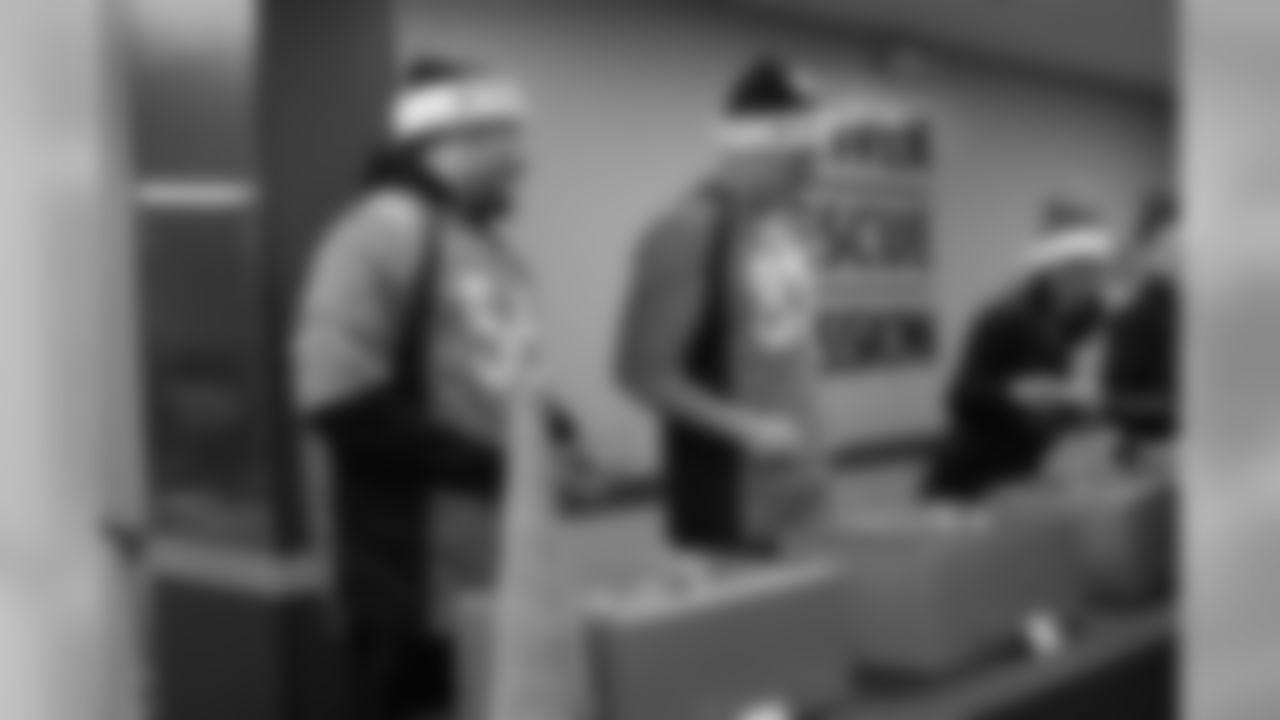 Shane Ray and Matt LaCosse serve dinner at the Denver Rescue Mission's 19th annual holiday party.
