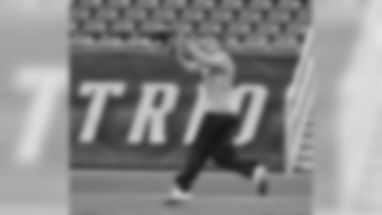 TE Joel Dreessen looks a ball into his hands during pregame warmups.