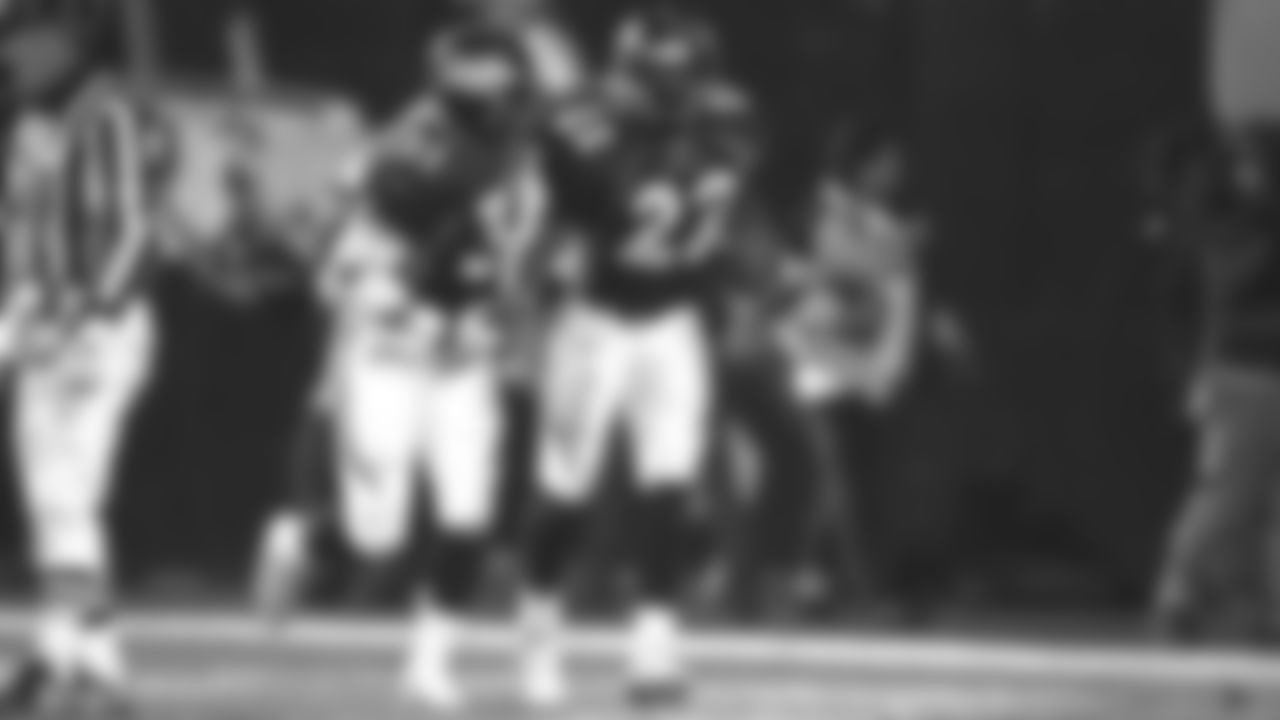 Running back Derek Loville congratulates Vaughn Hebron after he scored on a touchdown in the fourth quarter during the Broncos' 42-17 win over the Jacksonville Jaguars in the Wild Card round of the 1997 playoffs on December 27, 1997 at Mile High Stadium.
