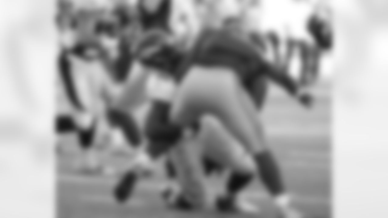 Robert Ayers makes a tackle for loss.