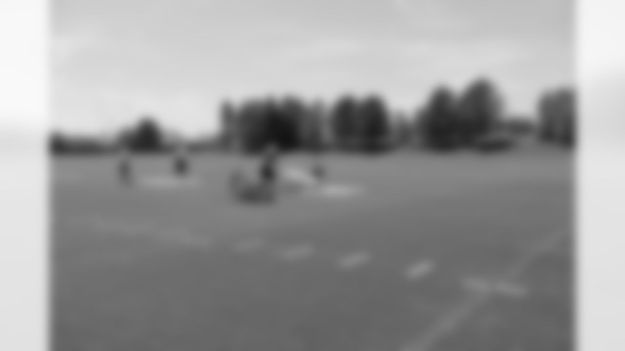 The grounds crew gets the field ready for camp by painting the numbers and lines.