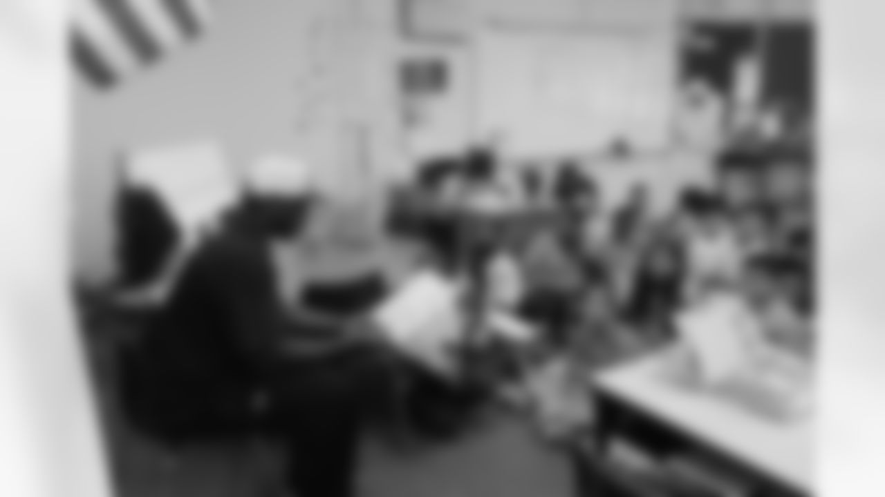 Jackson reads to students at Amesse Elementary.
