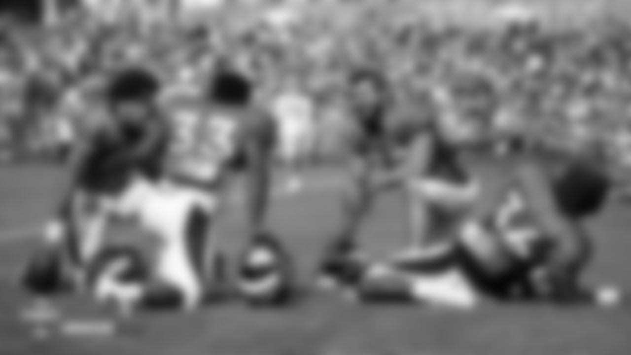 Running back Phillip Lindsay (2), running back De'Angelo Henderson Sr. (33), fullback Andy Janovich (32) and running back Dave Williams (36) relax before the fifth day of training camp on August 1, 2018, at UCHealth Training Center.