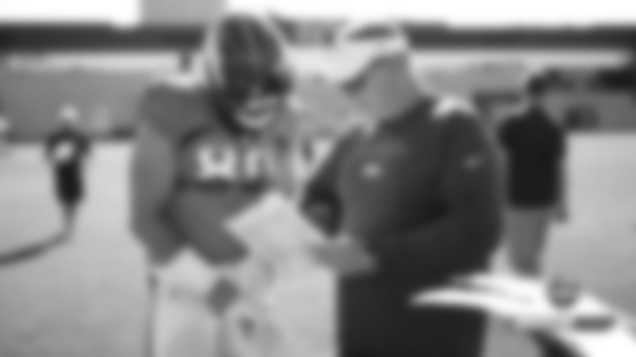 Jake Butt talks with Tight Ends Coach Wade Harman during practice on Day 16 of training camp on August 12, 2019.