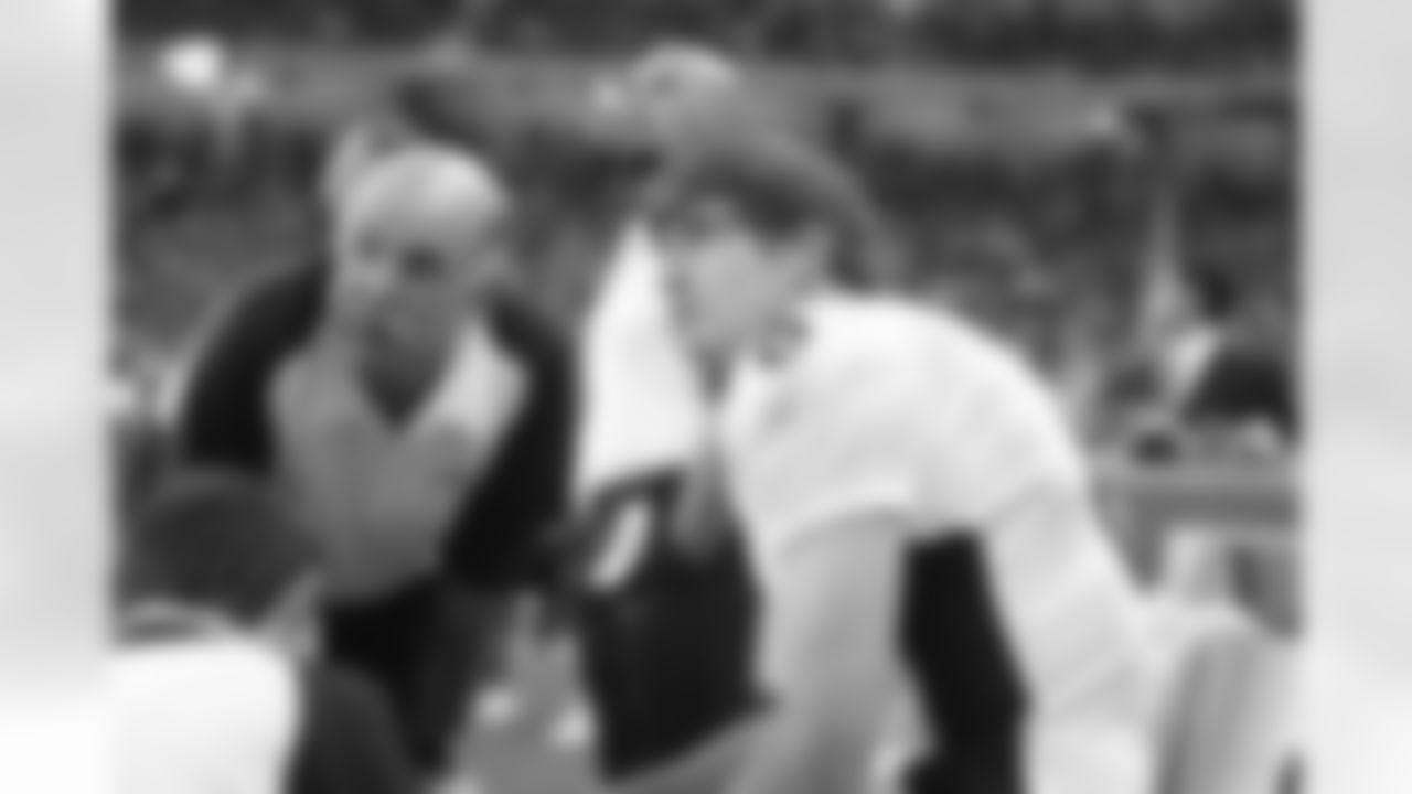 Denver Bronco quarterback Jay Cutler is checked over by head trainer Steve Antonopulos after being sacked by Detroit's Shaun Rodgers and injured on the second play of the second quarter