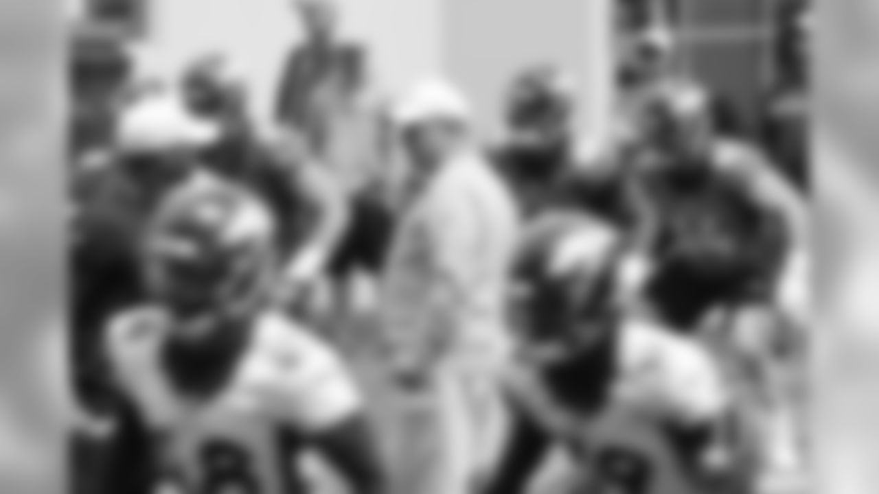 Head Coach Vic Fangio watches his team go through warmup drills during the first day of voluntary veteran minicamp on April 16, 2019.