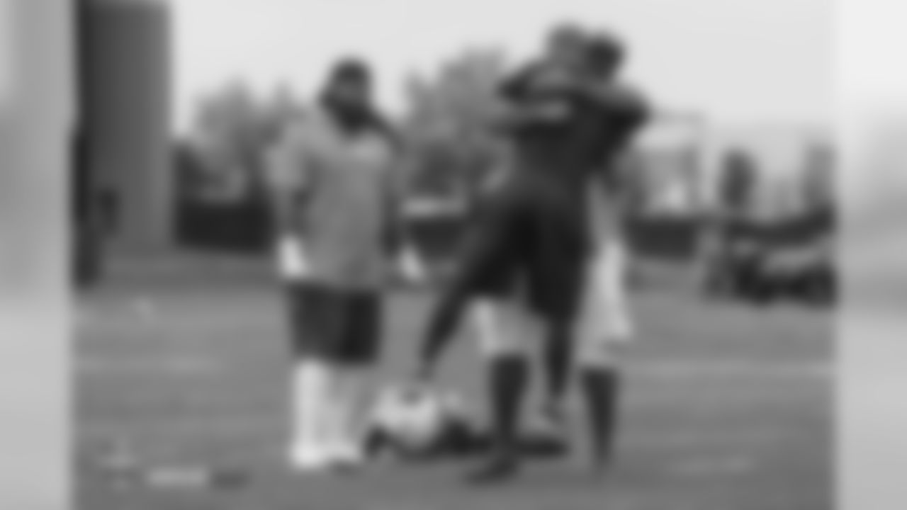 Former Bronco Kevin Vickerson lifts up Assistant Strength and Conditioning Coach Anthony Lomando with a big hug during the 10th day of training camp on August 8, 2018, at UCHealth Training Center.