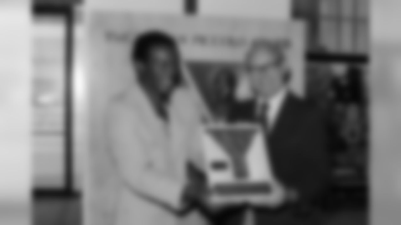 Floyd Little of the Denver Broncos is presented the YMCA-Brian Piccolo Award for humanitarian service at Helms Hall in Los Angeles on Nov. 20, 1973, by Dr. Robert W. Harlan, executive director of the YMCA's national council. The award, in memory of the late Chicago Bears' running back, was made to Little for his work against drug abuse among young people. (AP Photo/David F. Smith)