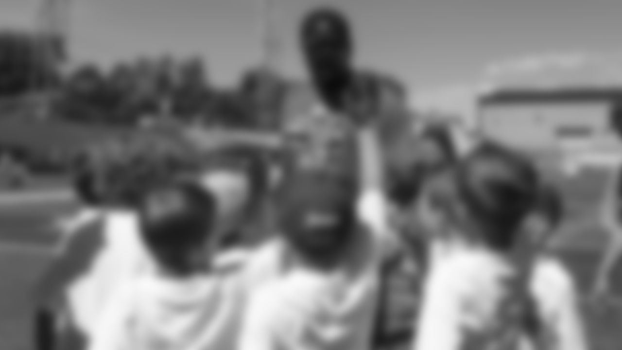 Von Miller interacts with children at his youth football camp at Englewood High School on June 20, 2019.