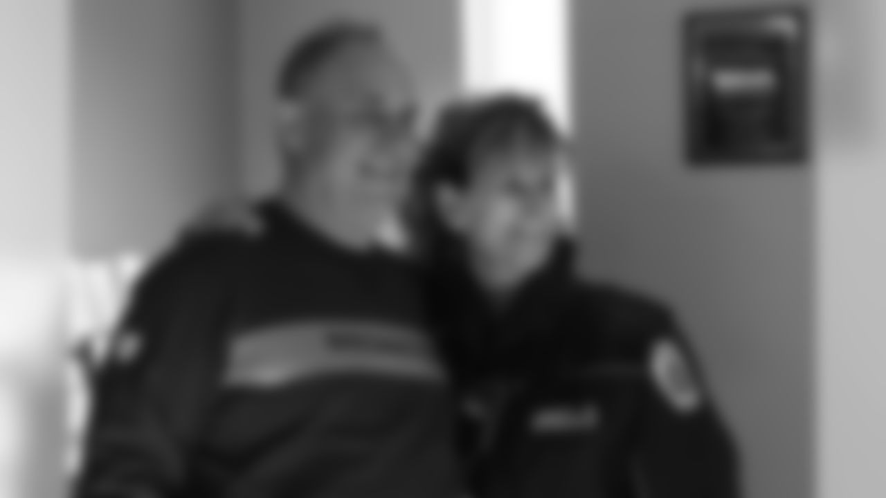 Head Coach Vic Fangio poses for a photo with a member of Aurora Fire Rescue during his visit for Random Acts of Kindness Week on February 20, 2019.