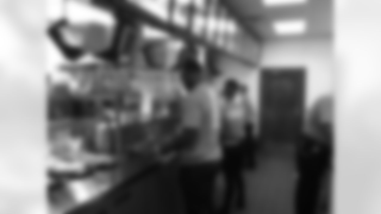 Cyril Obiozor helps with the food at Arby's as part of Be a Champion in the Community week.