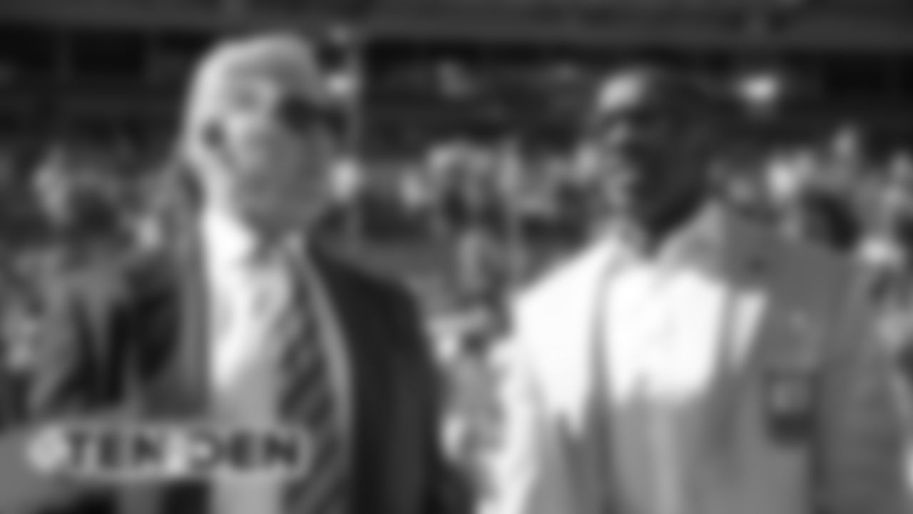 John Elway talks with Shannon Sharpe before the Broncos' game against the Tennessee Titans at Empower Field at Mile High on October 13, 2019. (Photo by Ben Swanson)