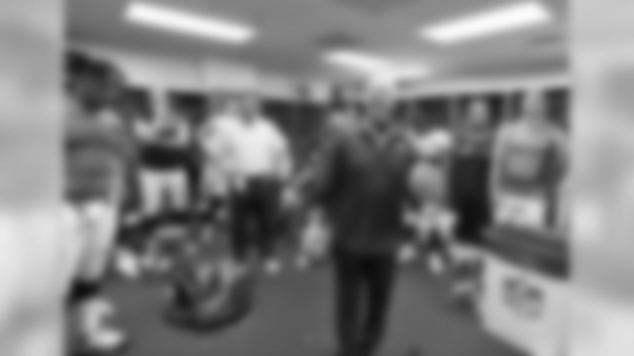 Fox addresses the team in the locker room after the win.