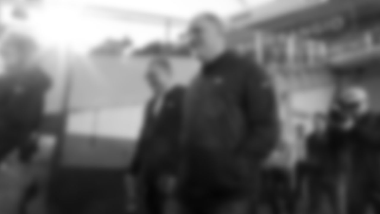 Head Coach Vic Fangio speaks with a staff member as they walk to the field at a meet-and-greet visit with team employees at Broncos Stadium at Mile High on March 19, 2019.