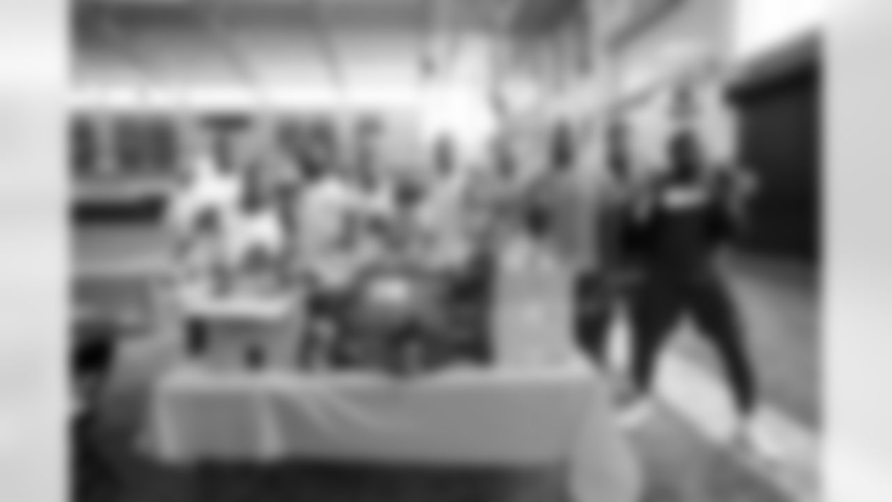 Jonathan Harris, Donnie Lewis Jr., McTelvin Agim, Jamar Johnson, Jerry Jeudy, Malik Reed, Aaron Patrick, Dre'Mont Jones and Baron Browning at an event packaging mental health supplies for local groups at UCHealth Training Center in Englewood, Colorado on May 24, 2022. (Photo by Ben Swanson)