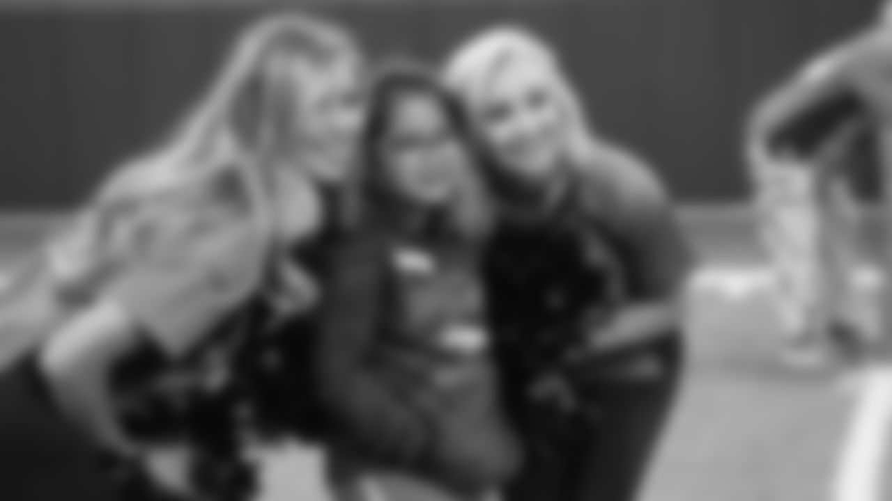 A young girl poses for a photo with two Denver Broncos Cheerleaders during a PLAY 60 All-Ability Clinic with the National Sports Center for the Disabled for 200 athletes at UCHealth Training Center at April 30, 2019.