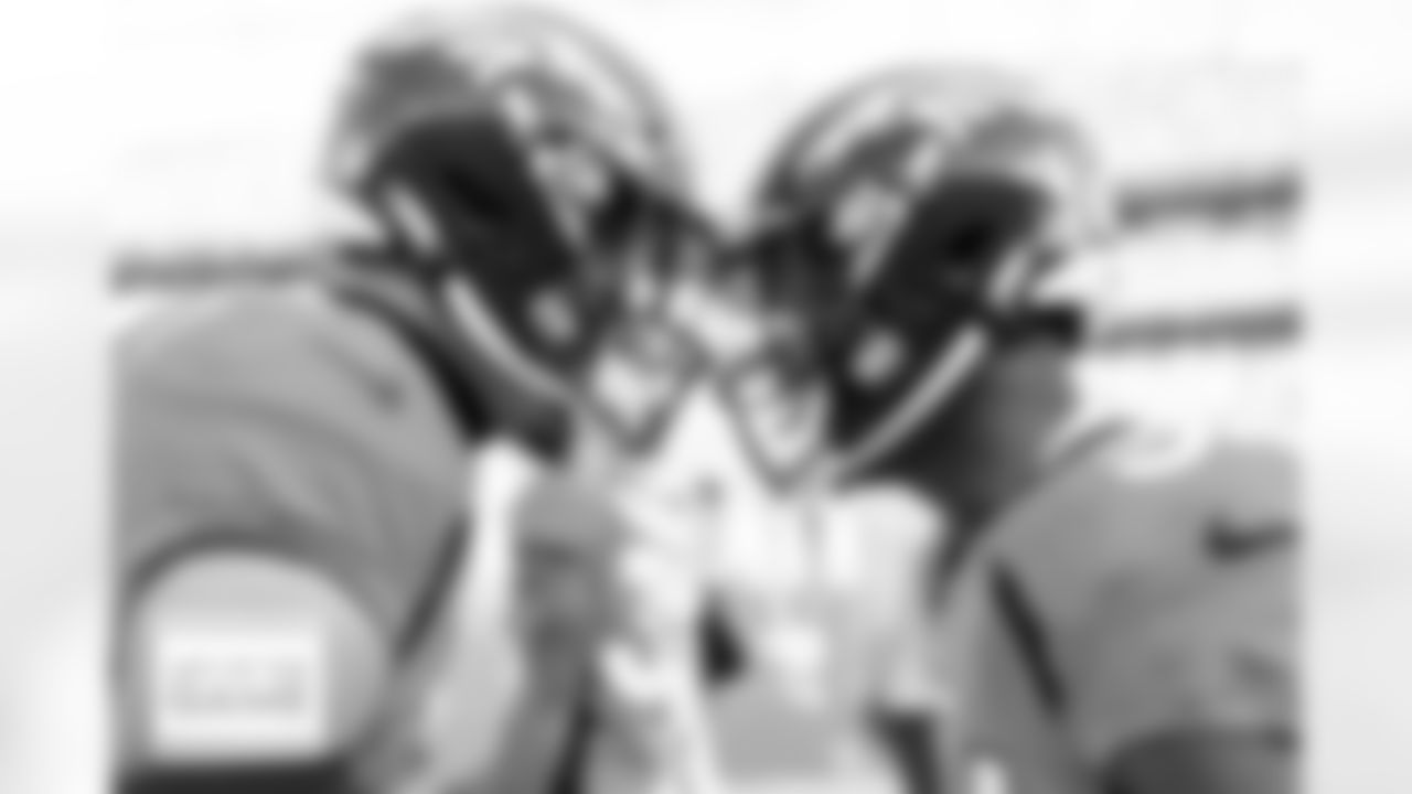 Justin Simmons and Essang Bassey on the sideline before the Broncos' Week 18 game against the Los Angeles Chargers at Empower Field at Mile High in Denver, Colorado on January 8, 2023. Photo by Ben Swanson/DenverBroncos.com