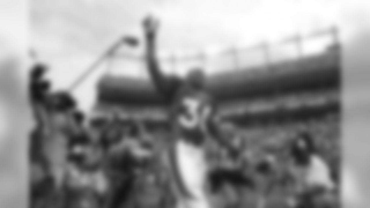 Denver Broncos running back Terrell Davis waves to the fans as he is introduced prior to the start of Monday night's NFL exhibition game between the San Francisco 49ers and the Denver Broncos in Denver on Monday, Aug. 19, 2002. The Broncos, at Davis' request, placed him on injured reserve days later, ending his season and effectively ending the career of a player who was both a Super Bowl and regular-season MVP. (AP Photo/Jack Dempsey)