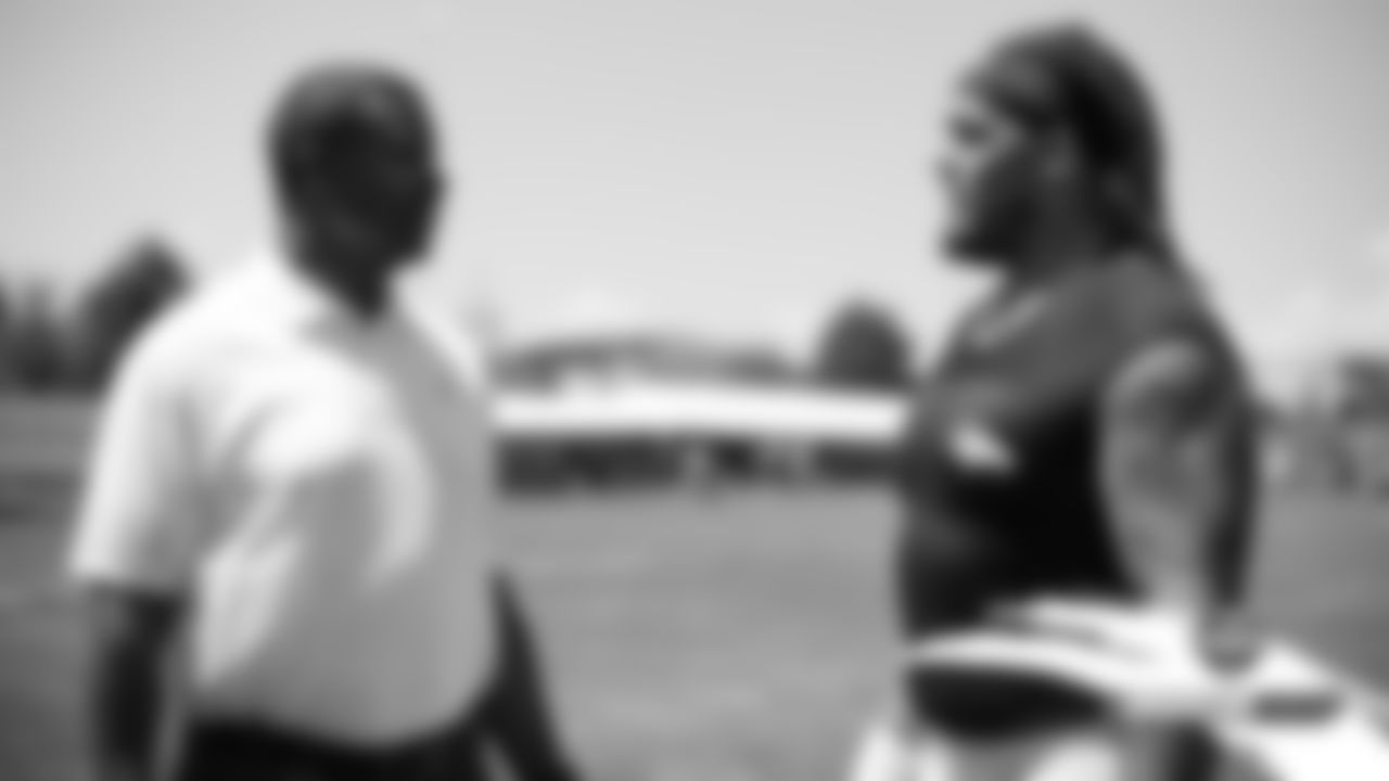 Ring of fame former safety Steve Atwater talks with Derek Wolfe at practice on Day 5 of training camp on July 22, 2019.