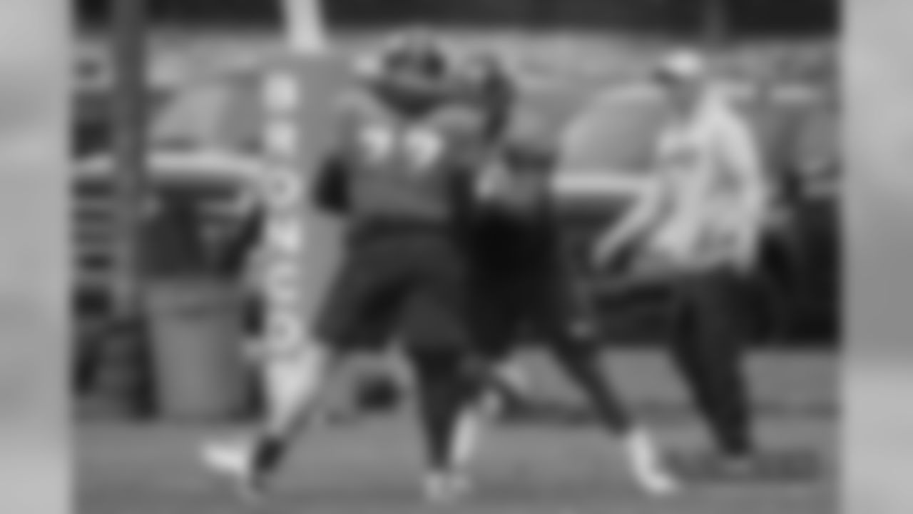 Billy Turner and Elijah Wilkinson with Offensive Line-Tackles Coach Chris Strausser at practice at UCHealth Training Center on October 11, 2018.
