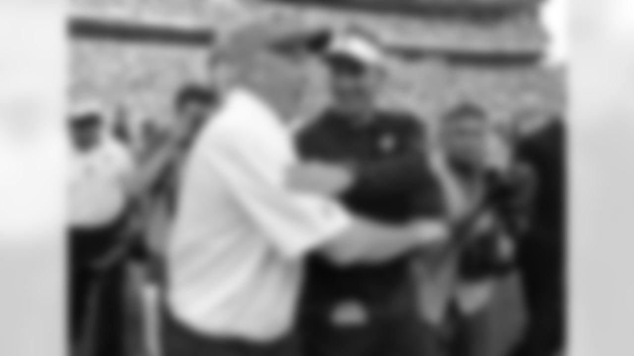 Head Coaches John Fox and Dennis Allen greet each other after the game.