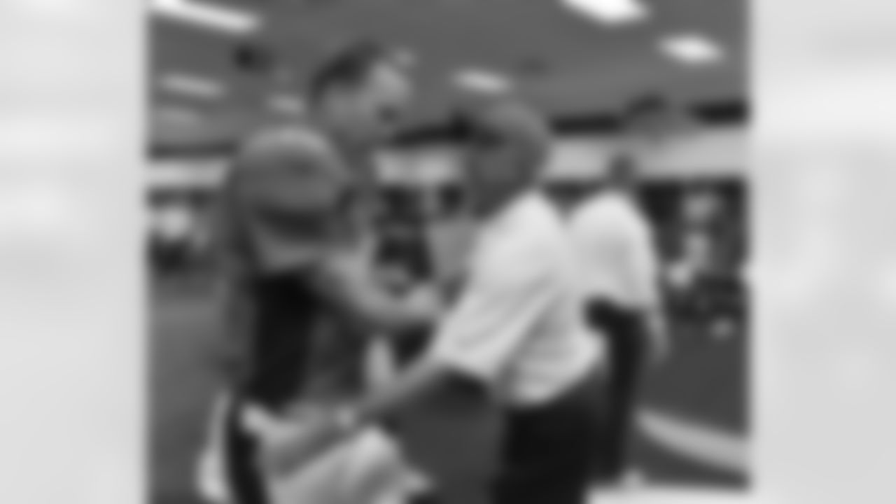 Head Coach John Fox congratulates Manning in the locker room after the win.