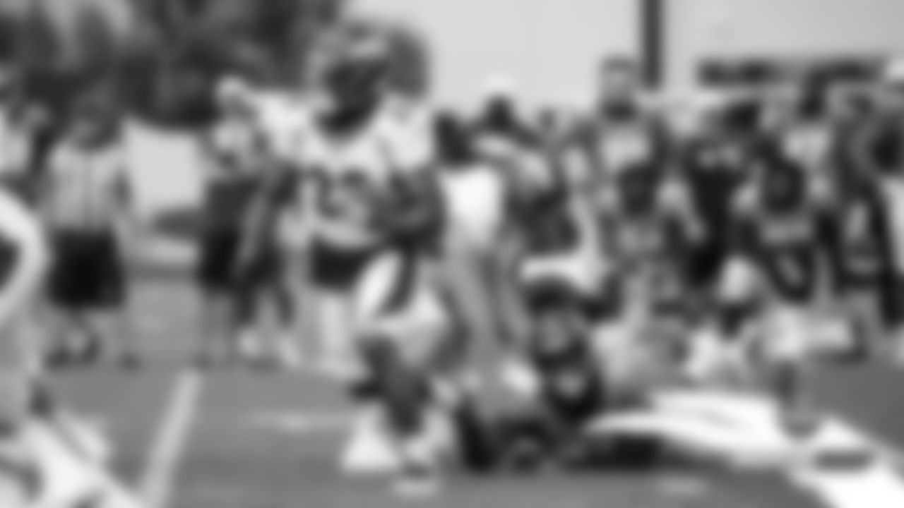 Von Miller tries to hold on to Royce Freeman's shoelaces during practice on Day 10 of training camp on July 29, 2019.