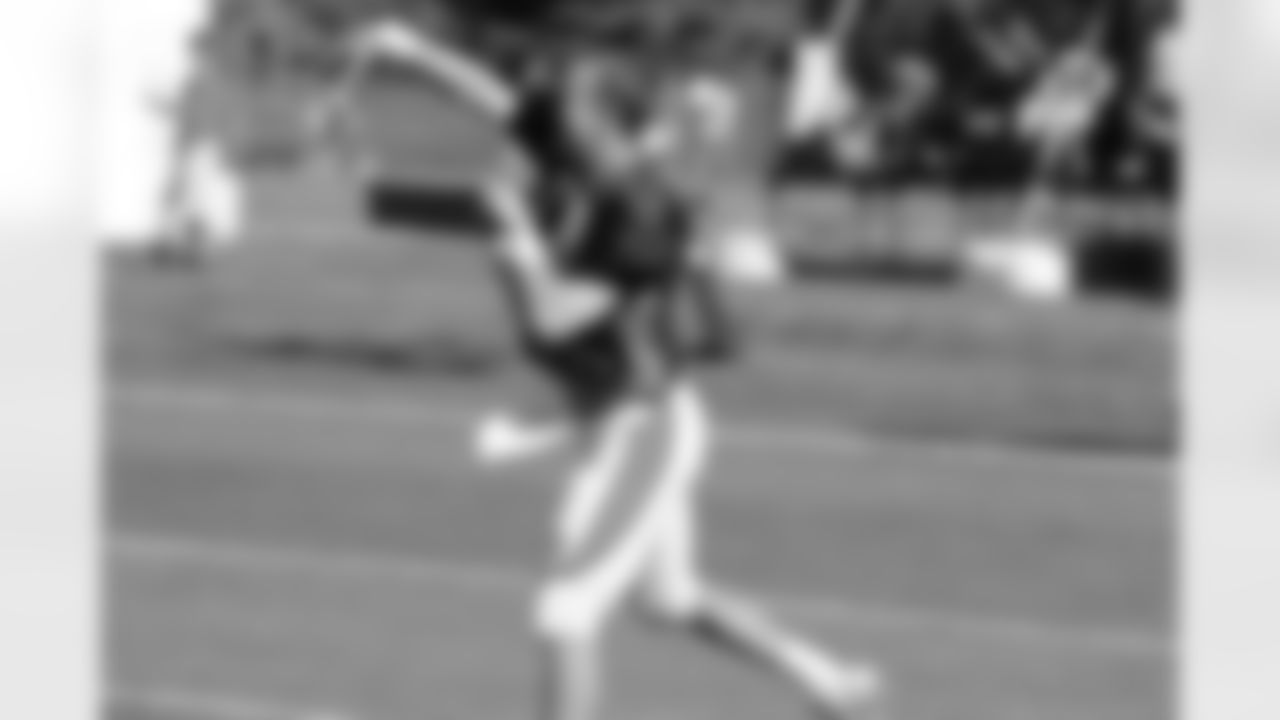 QB Peyton Manning warms up before practice.